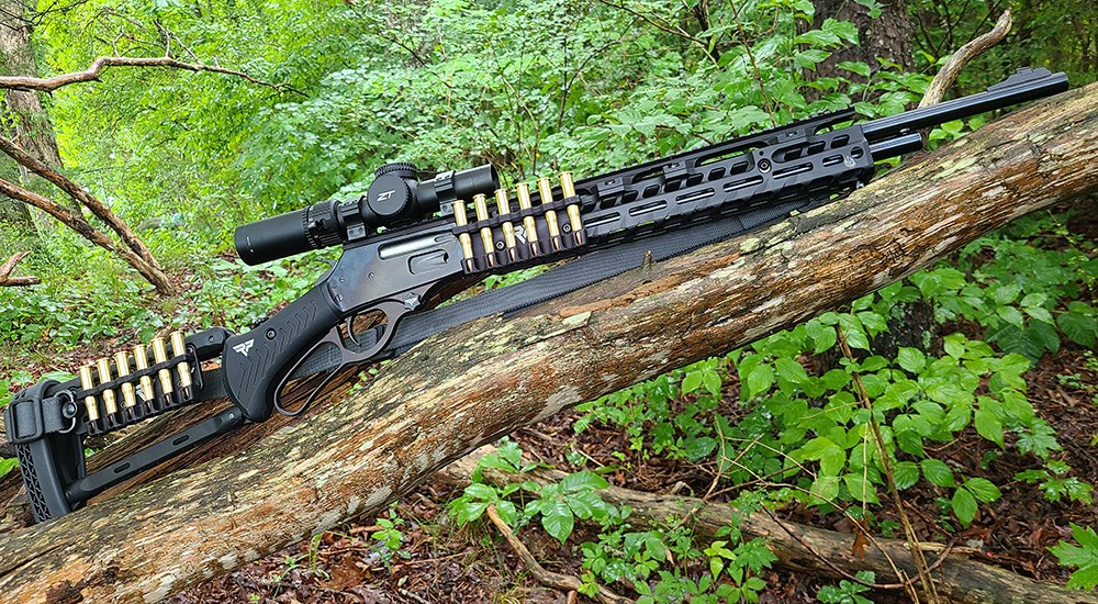 Rossi R95 lever action rifle with aftermarket stock and barrel accessories.
