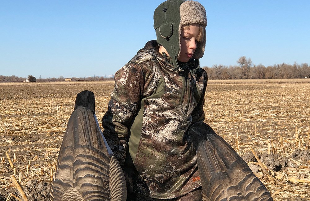 Young Hunter Setting Goose Decoys