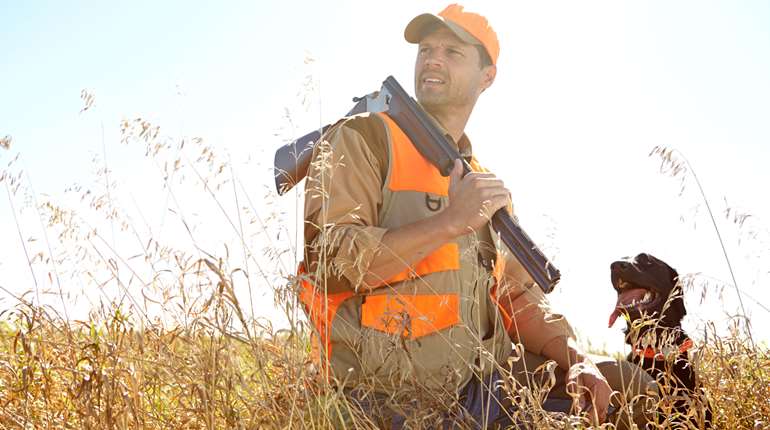 Man Hunting With His Dog In Tall Grass 2026 09 24 14 46 51 Utc