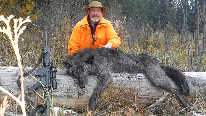 Hunter with black wolf