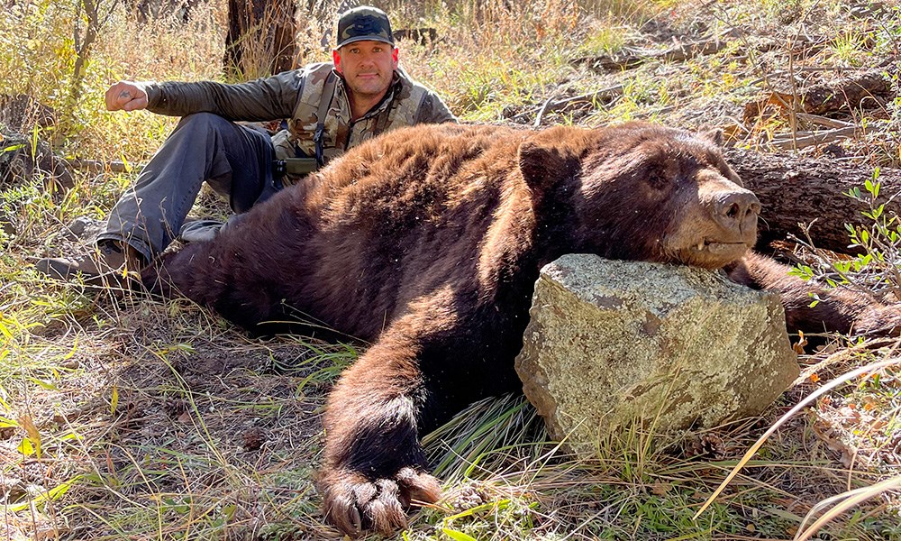 Hunter with bear taken in New Mexico