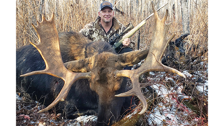 Hunter with moose taken in Alberta, Canada