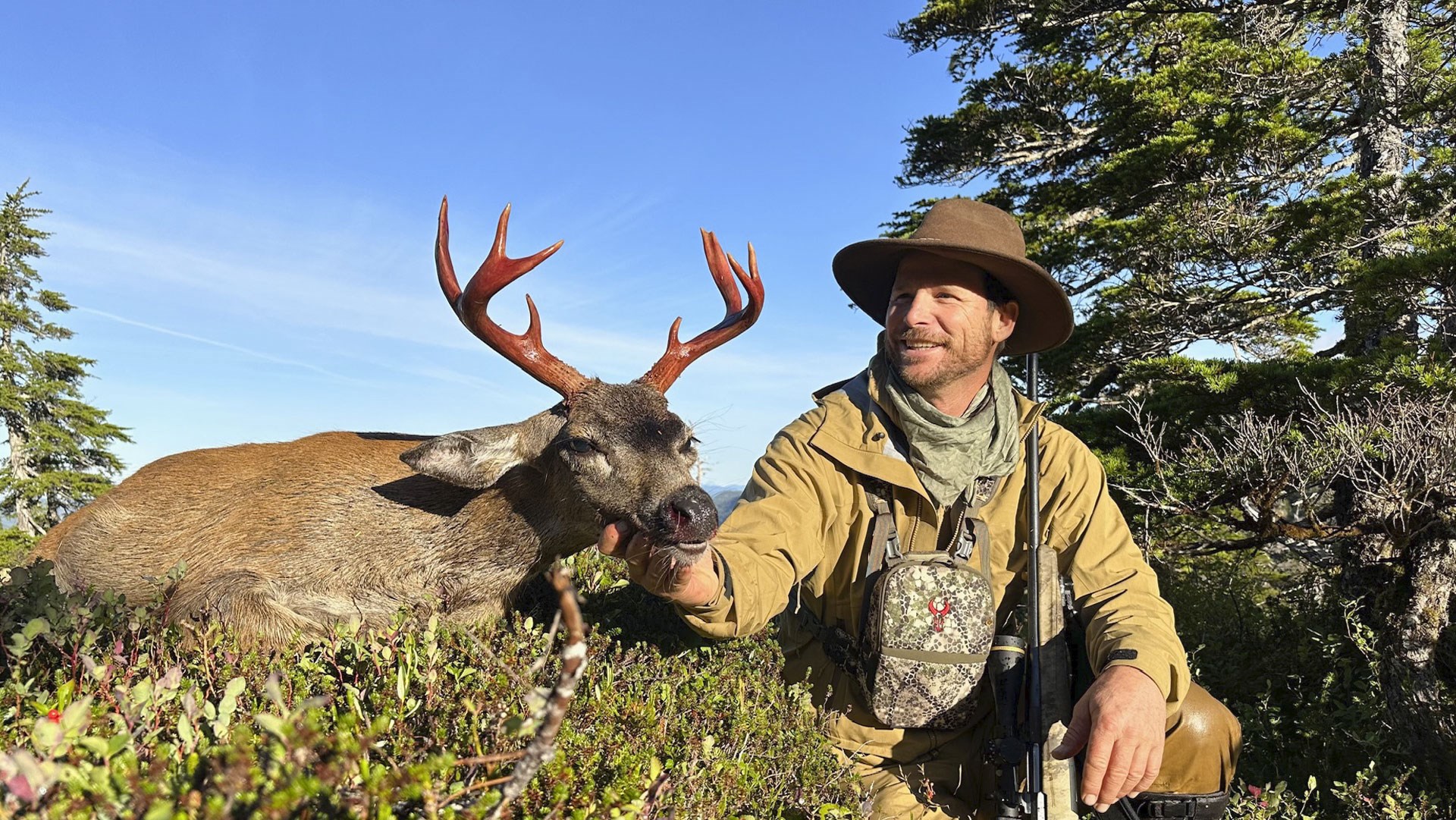 Hunter with Sitka Deer