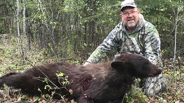 Hunter with color-phase black bear