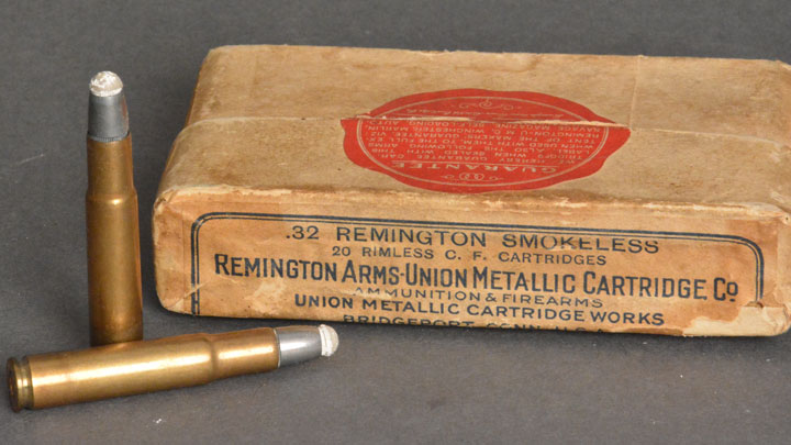 .32 Remington in a white box with two cartridges beside it