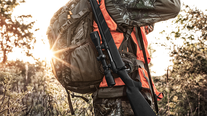 Hunter Walking in Woods with Rifle on Shoulder