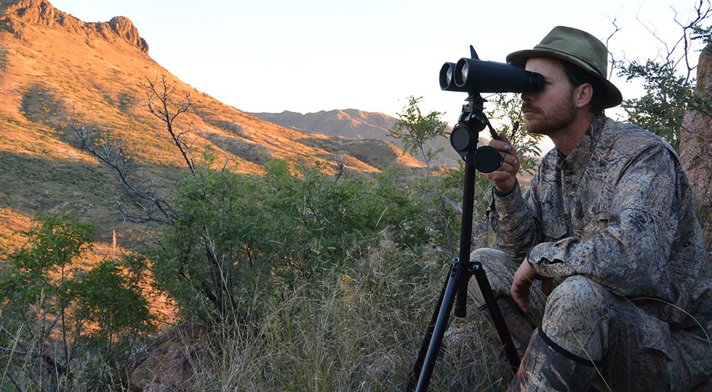 Male Hunter with Binocular Viewing Distant Mountainside