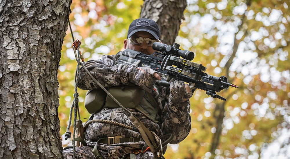 Hunter in tree stand using TenPoint TRX 515 crossbow.