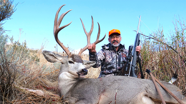 Hunter with Mule Deer Buck