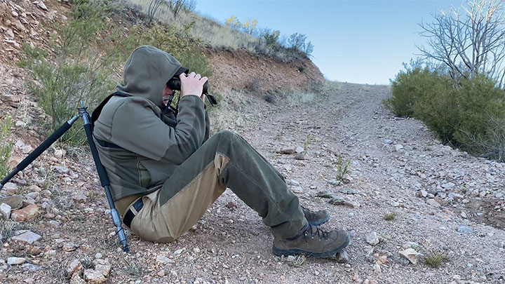 Man with binoculars glasses a section of plains