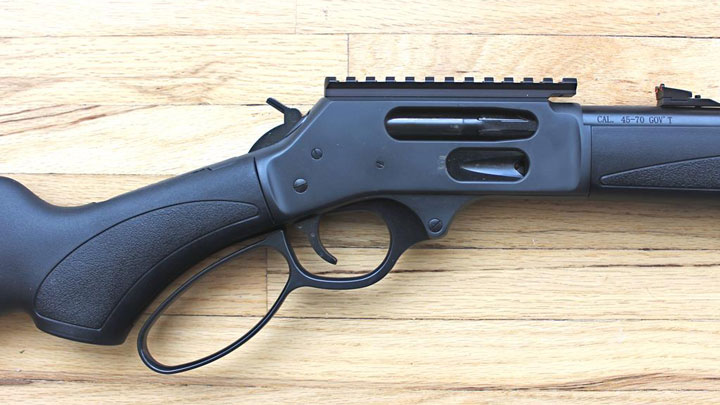 Closeup of the gun's receiver, on the same wooden background