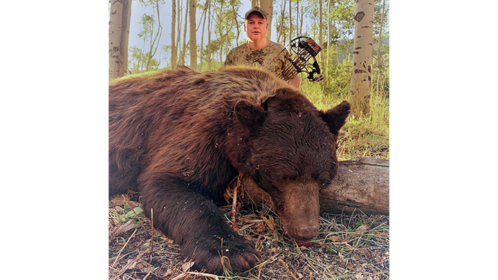 Hunter with Colorado archery bear taken in Gunnison National Forest