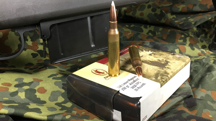 Cartridge on box in front of rifle