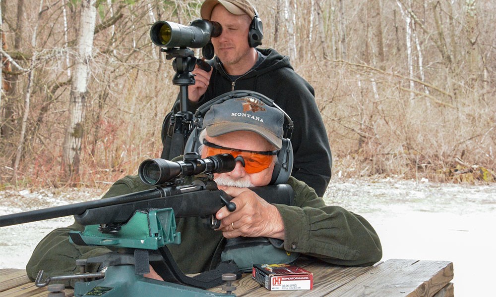 Man Using Spotting Scope to Analyze Groups for Shooter