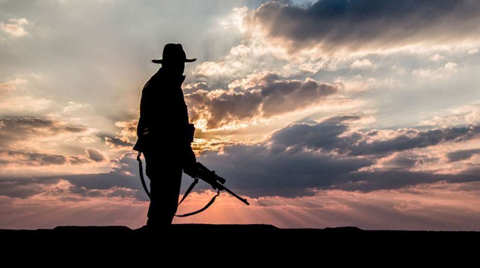 Hunter Sillouhetted Against Sunset