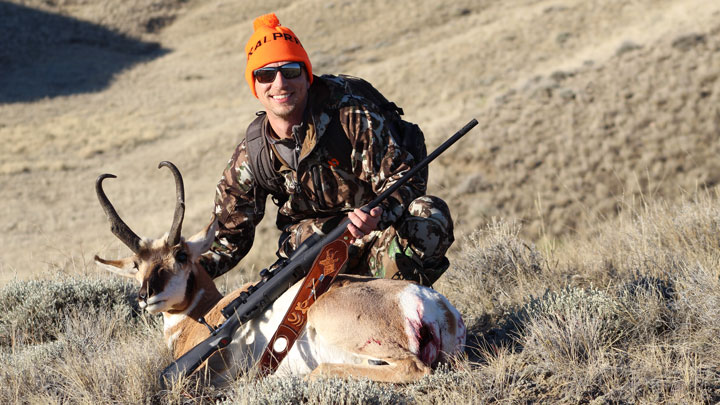 Hunter behind a downed Antelope on the plains