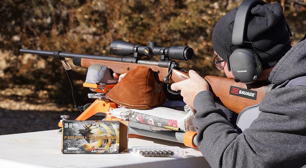 Male shooting bolt action rifle loaded with Federal Premium Terminal Ascent ammunition.