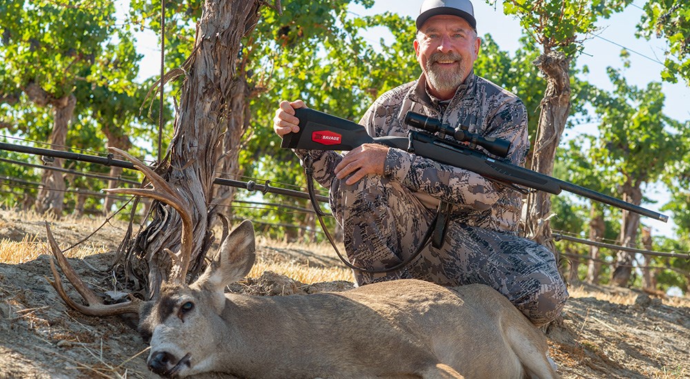 Male hunter posing with blacktail deer in California.