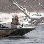 Camo jet boat on river snow men in boat camo cold