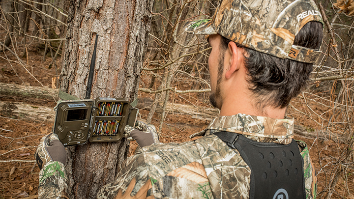 Hunter setting up trail camera